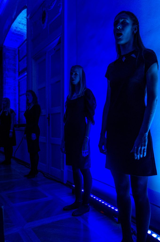 Members of the choir next to the walls