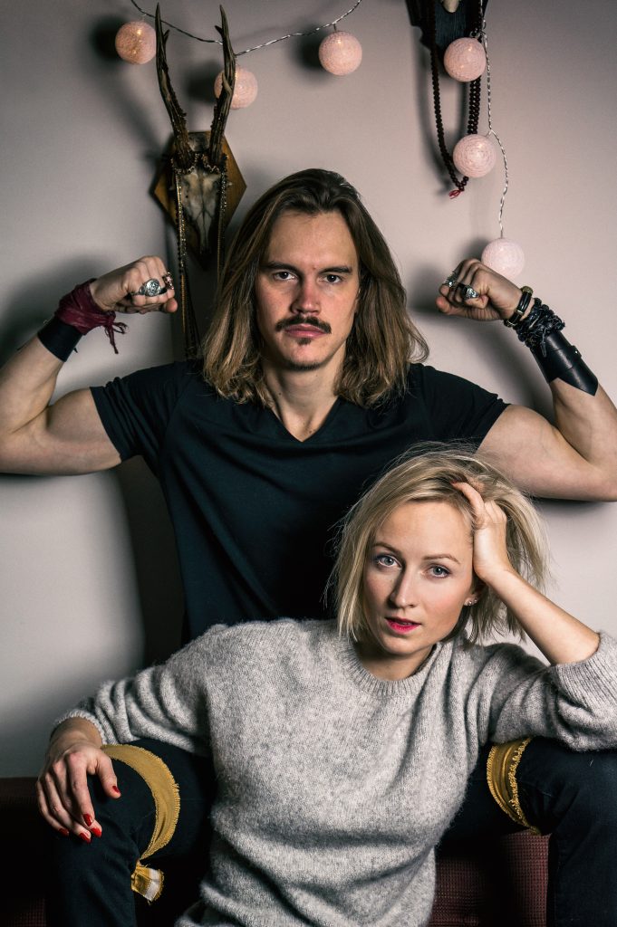 Man shows muscles behind woman