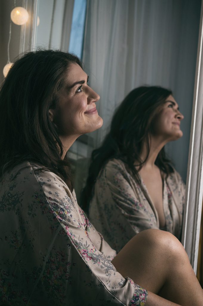Woman sitting in front of a mirror